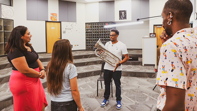 Second from right, East Middle School band and orchestra teacher Jimmy Lee Day II shows off a tuba to the roadtrippers.